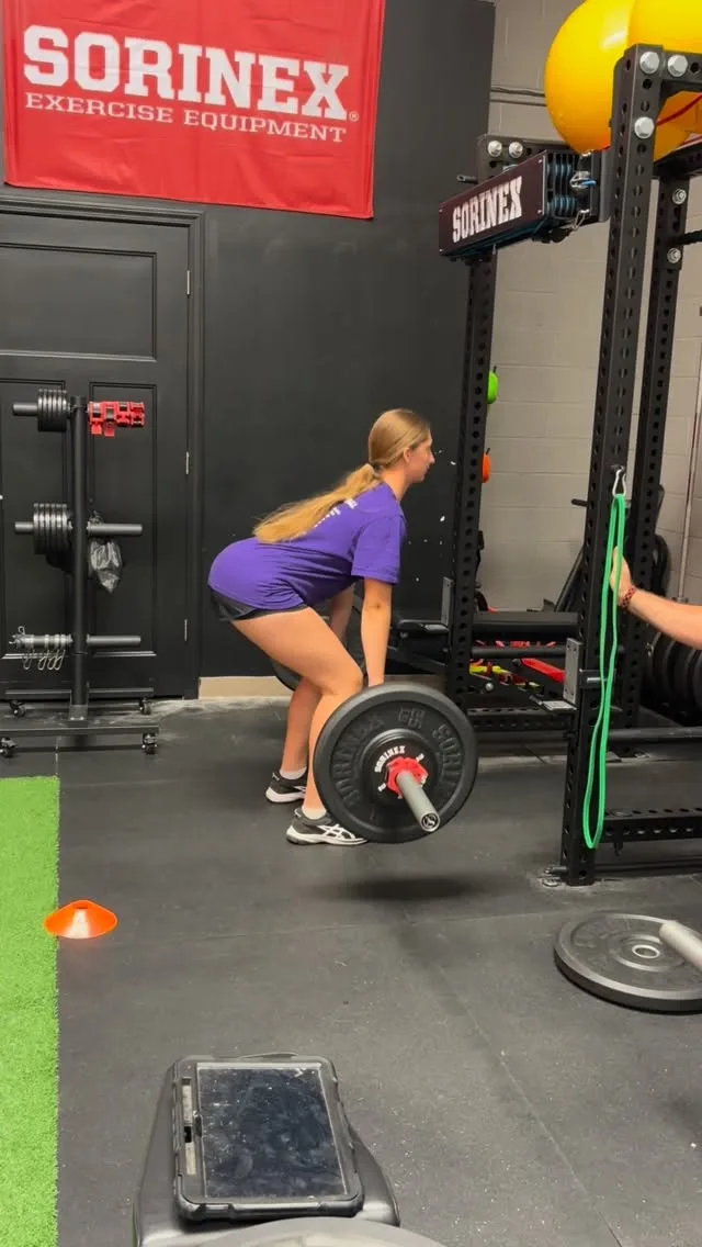 An Elite Performance athlete deadlifting at the rack during a coached strength session