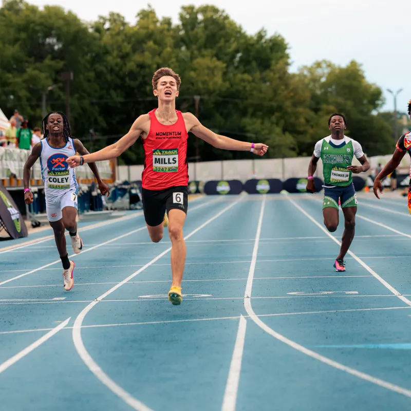 A Momentum Track Club sprinter crossing the finish line first at Adidas Track Nationals